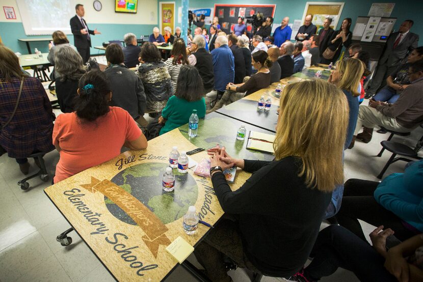 DISD chief operating officer Scott Layne (top left) takes questions about a proposed...