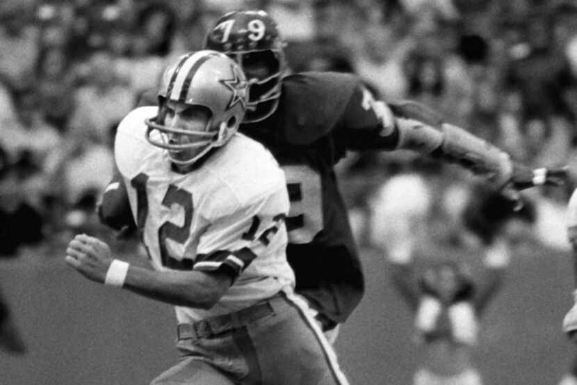 Roger Staubach (12) scrambles from a New York Giants defender during a game played on Oct....