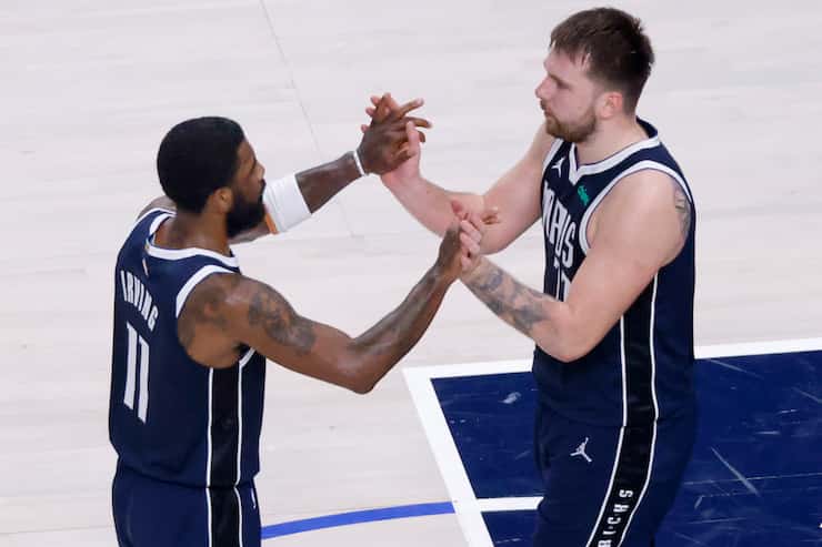 Dallas Mavericks guards Kyrie Irving (11) and Luka Doncic (77) ihigh five one another late...