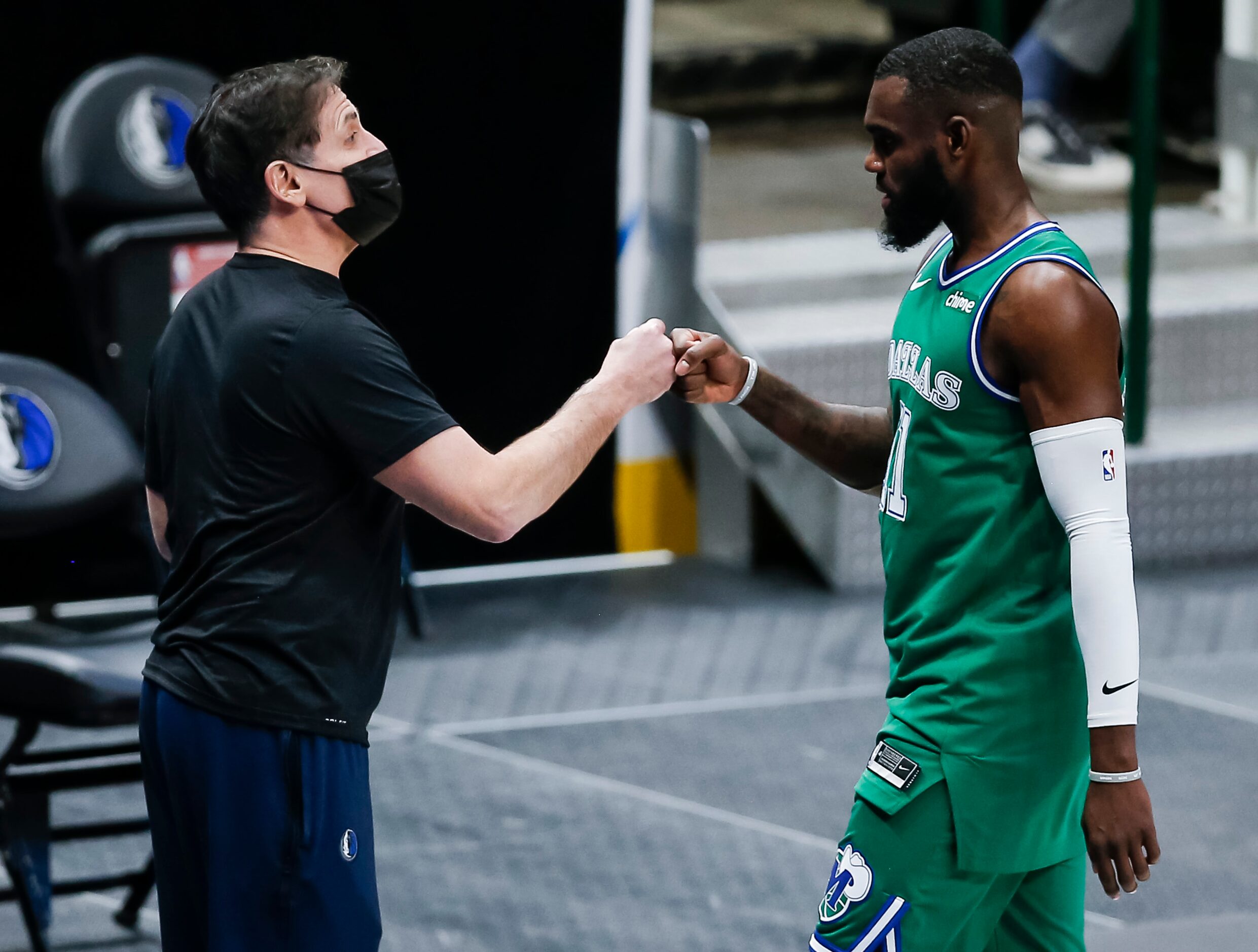 Dallas Mavericks owner Mark Cuban congratulates forward Tim Hardaway Jr. (11) after a 102-92...