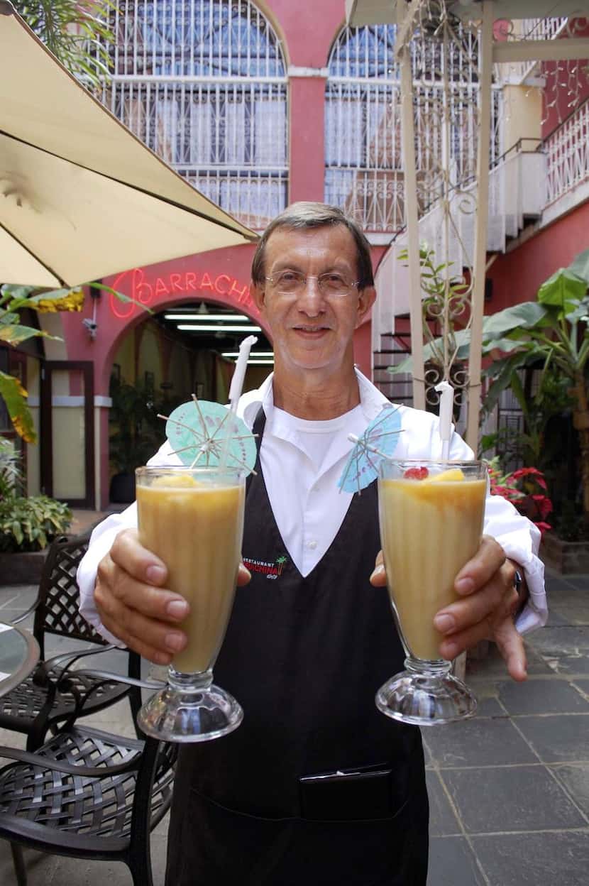 
Above: A waiter delivers the piña coladas at Barrachina in San Juan, the restaurant where...