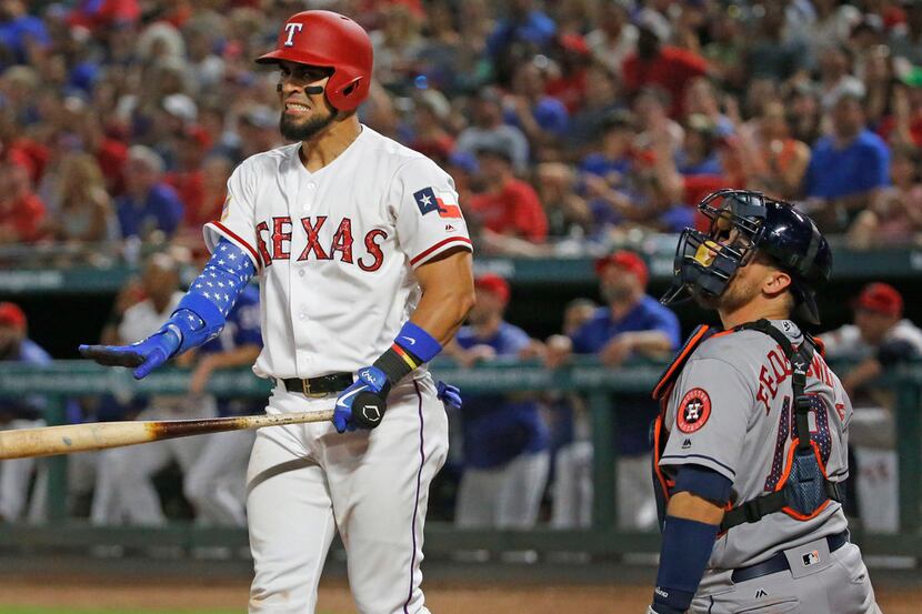 Texas Rangers Robinson Chirinos (61) watches the flight of a long foul fly that he hit with...