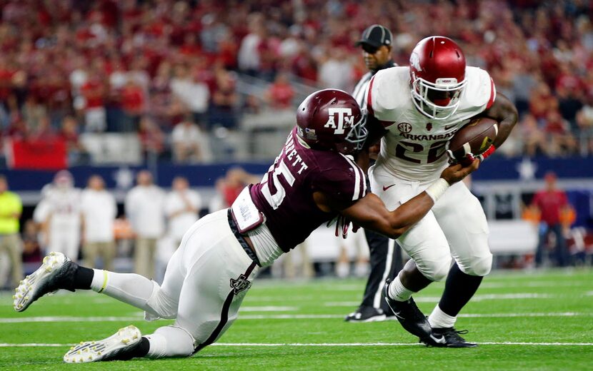 Texas A&M Aggies defensive lineman Myles Garrett (15) drags down Arkansas Razorbacks running...