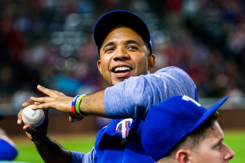 Texas Rangers shortstop Elvis Andrus (1) throws a ball to a fan during the eighth inning of...