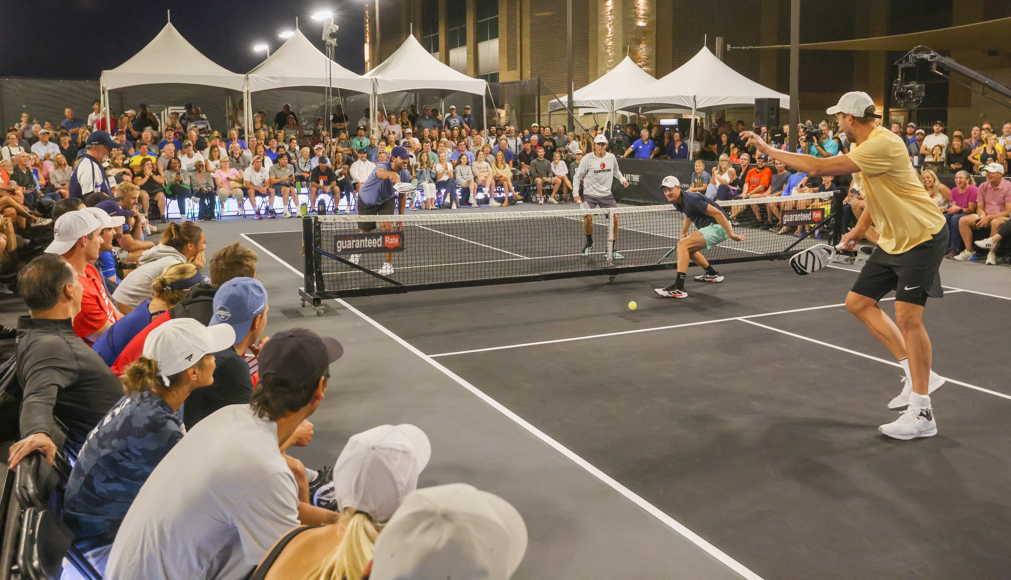 Tony Romo (left), Spencer Smith (center), Riley Newman and Dirk Nowitzki (right) play a...