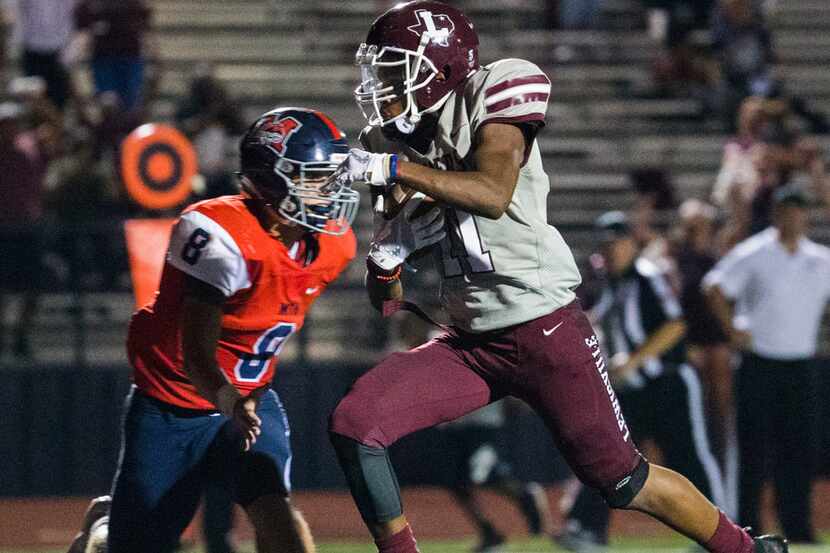Lewisville and wide receiver Brandon Rolfe (11), pictured scoring a touchdown against...