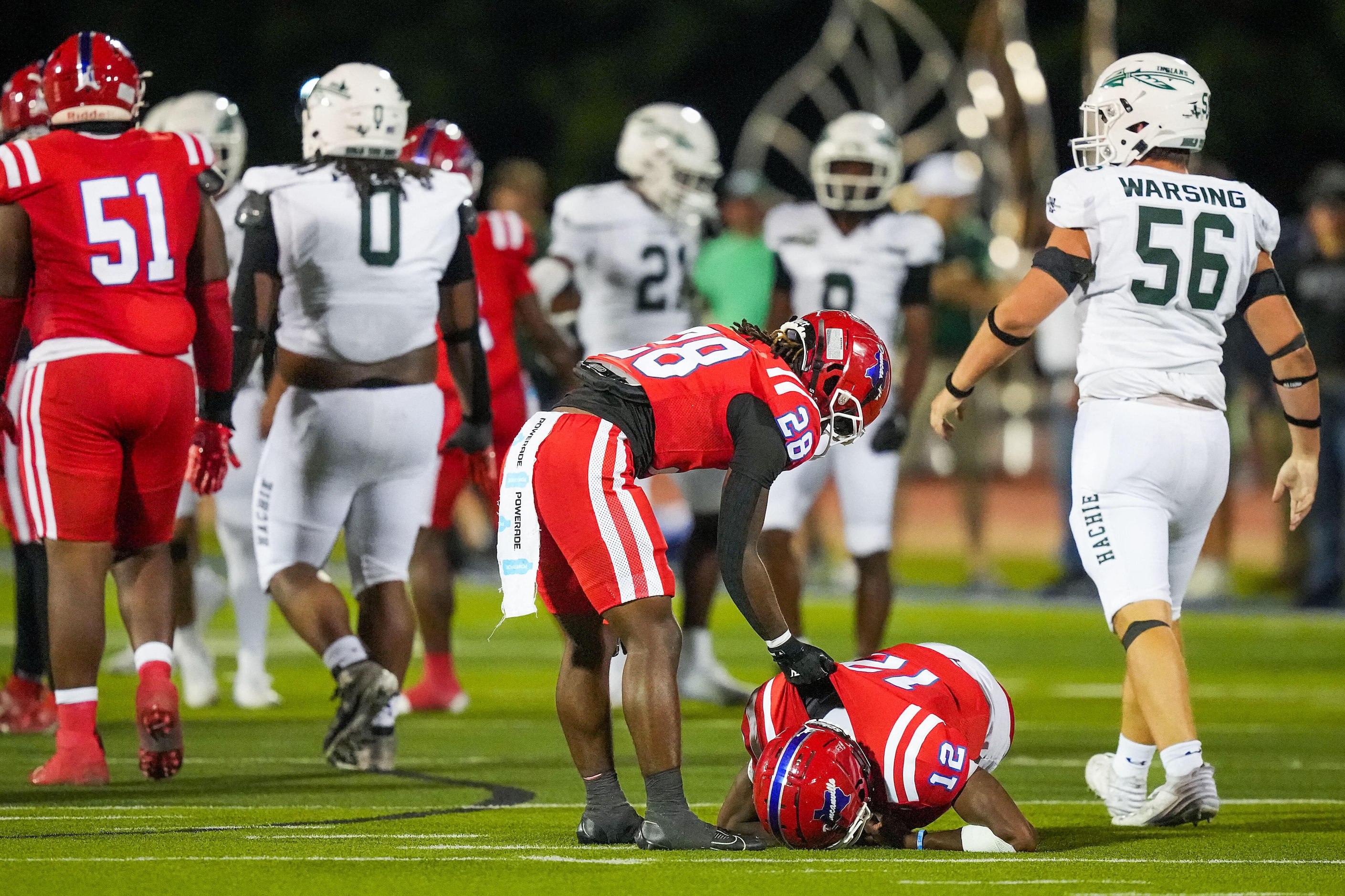 Duncanville running back Devine Green (28) checks on quarterback Keelon Russell (12) after...