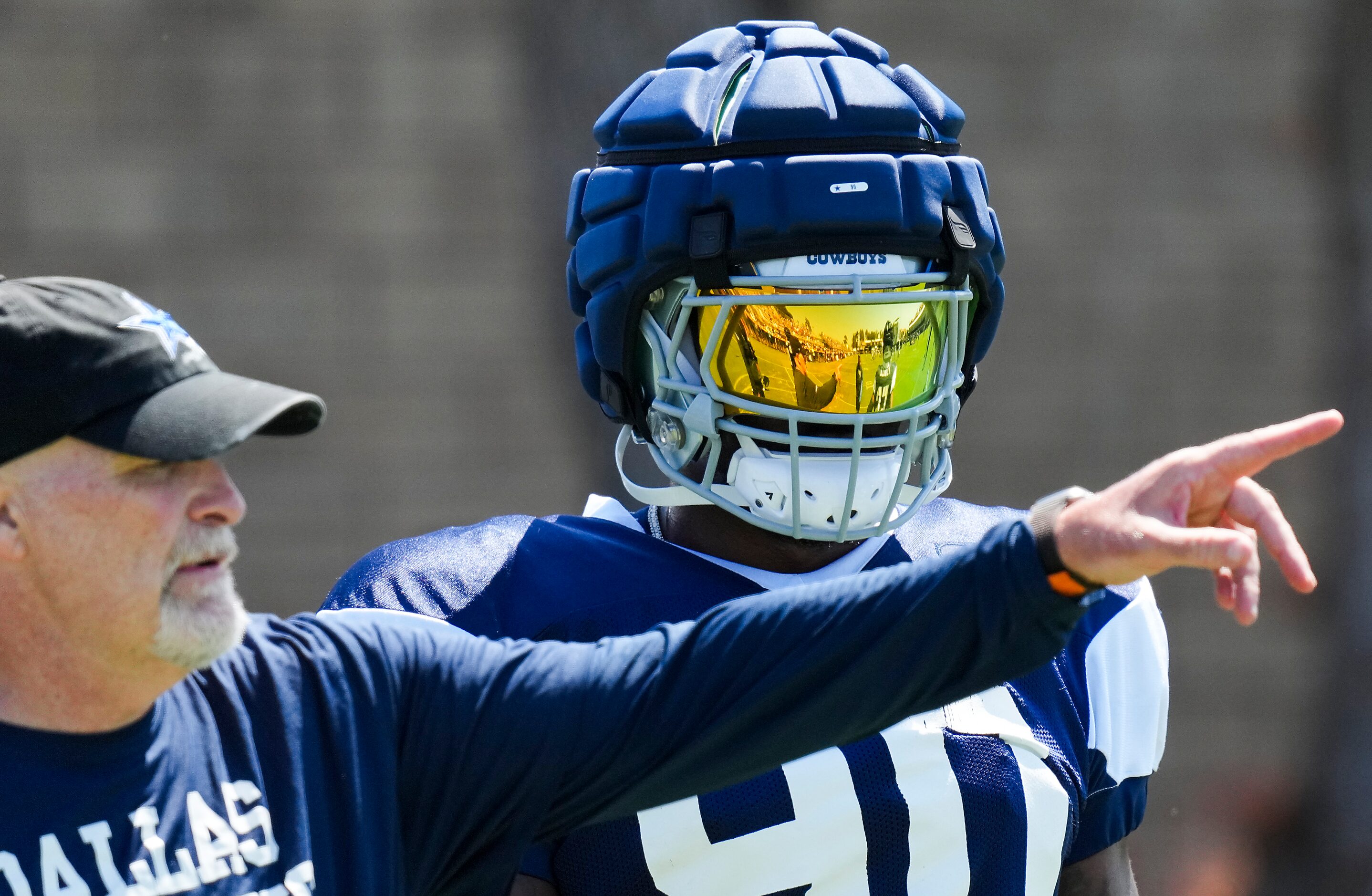 Dallas Cowboys defensive end Demarcus Lawrence (90) listens to defensive coordinator Dan...