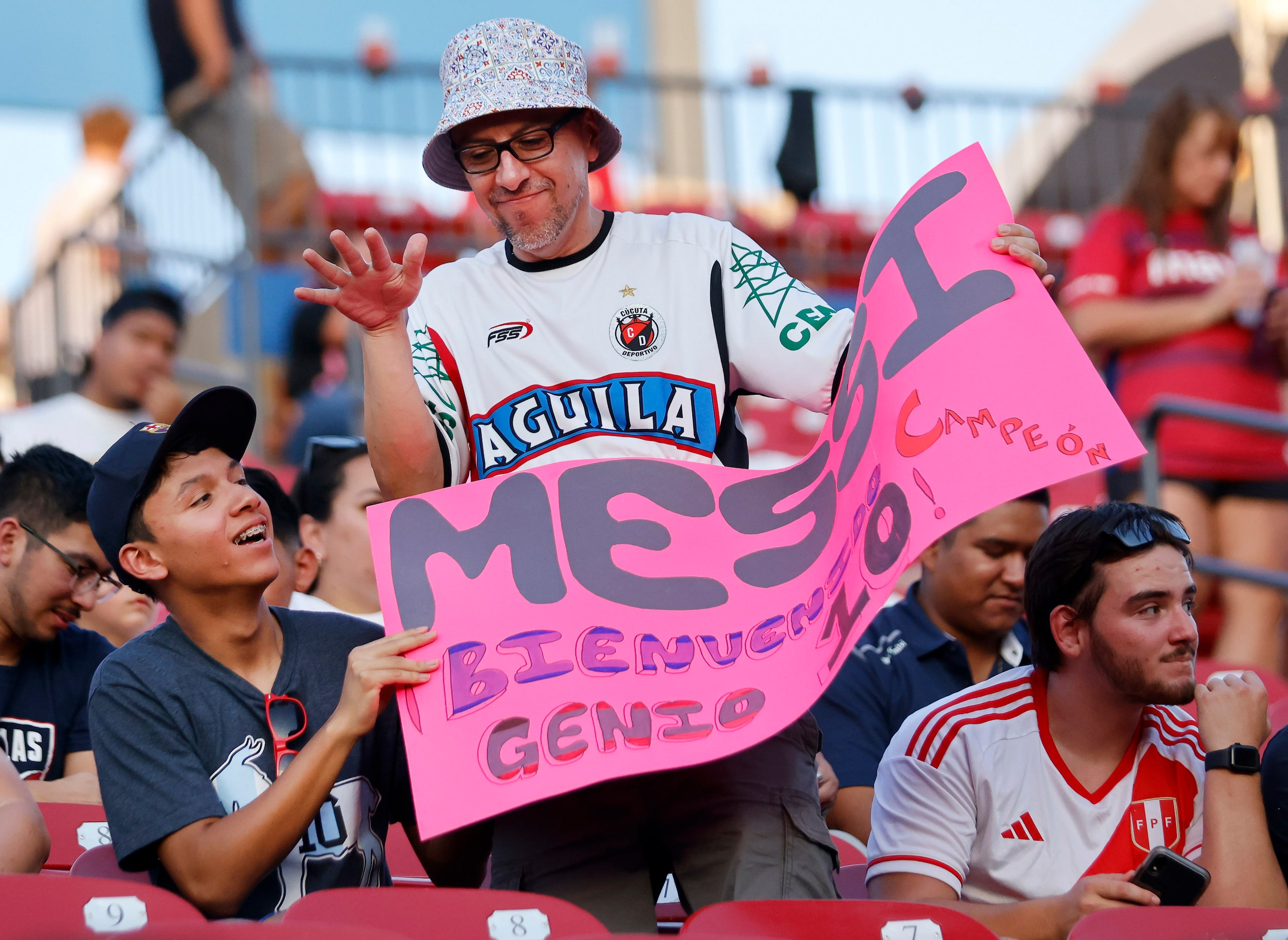 Fans of Inter Miami’s Lionel Messi dance in their seats before he takes the pitch for...