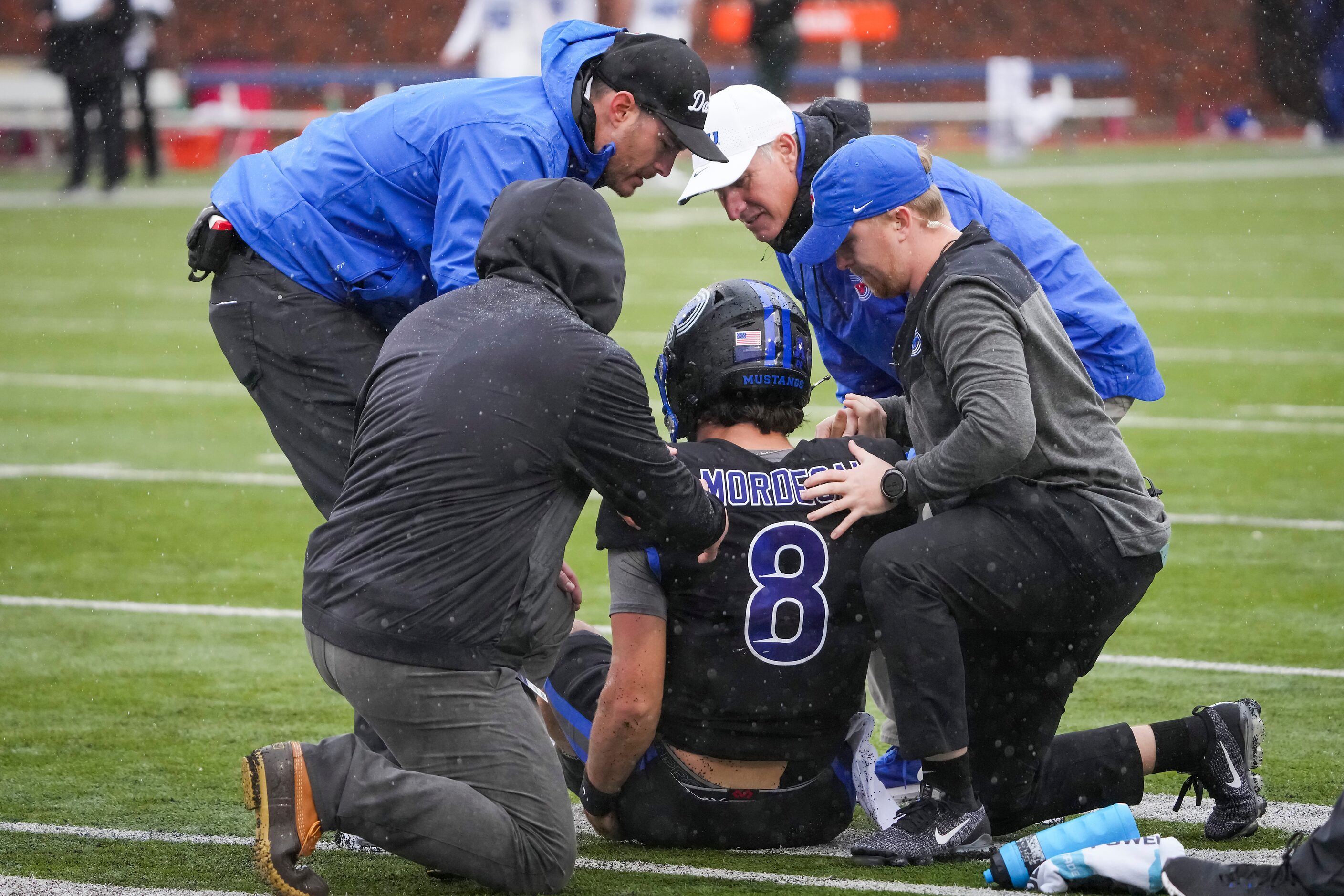 SMU quarterback Tanner Mordecai (8) receives attention after being injured on a scramble...