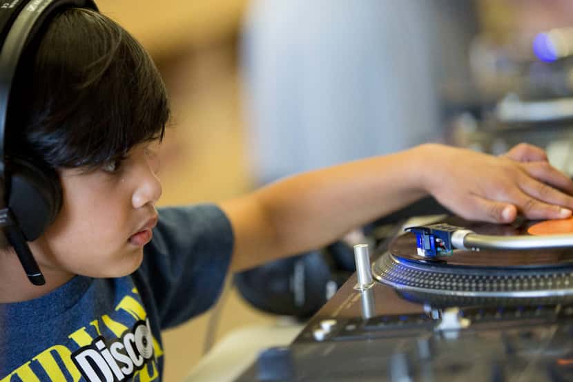 Jayden Shroff, 3, of Plano, tries out a turntable during Kids Dig, a day of record digging...