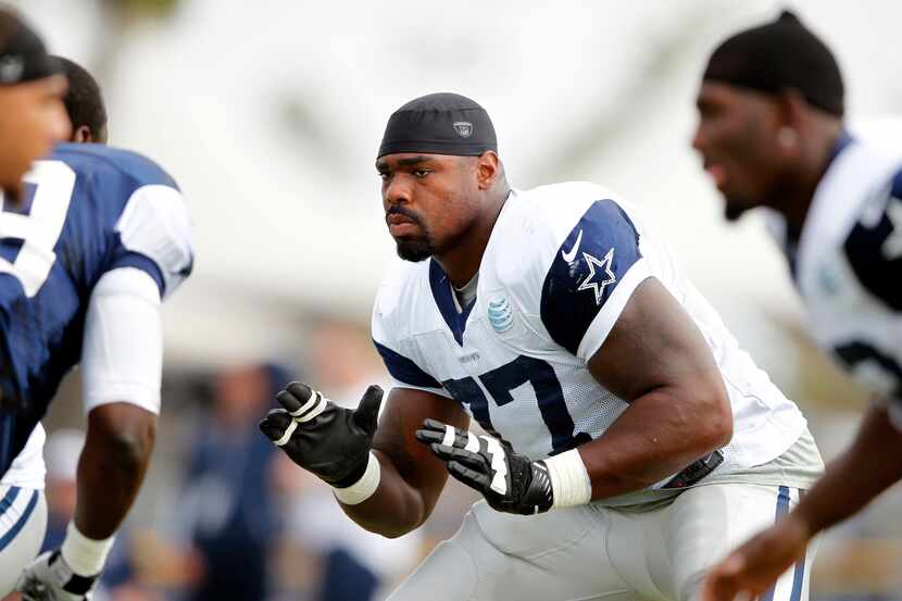 Dallas Cowboys tackle Tyron Smith (77) prepares to block during the afternoon practice at...