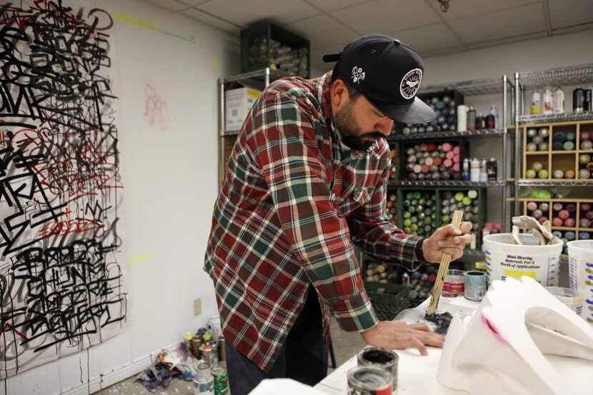Urban Artist DOSE at  work in his studio at the Fairmont Dallas Hotel, where he was the...