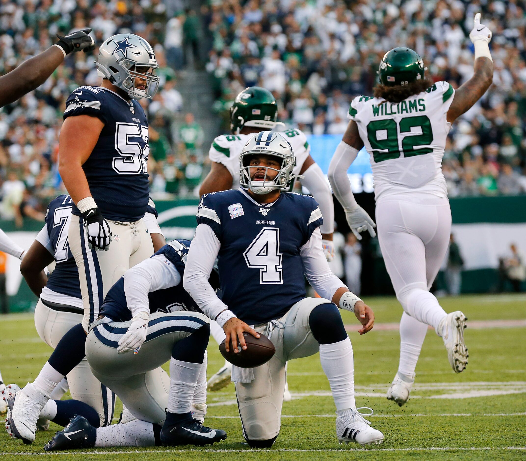 Dallas Cowboys quarterback Dak Prescott (4) gets back to his feet after being stopped short...