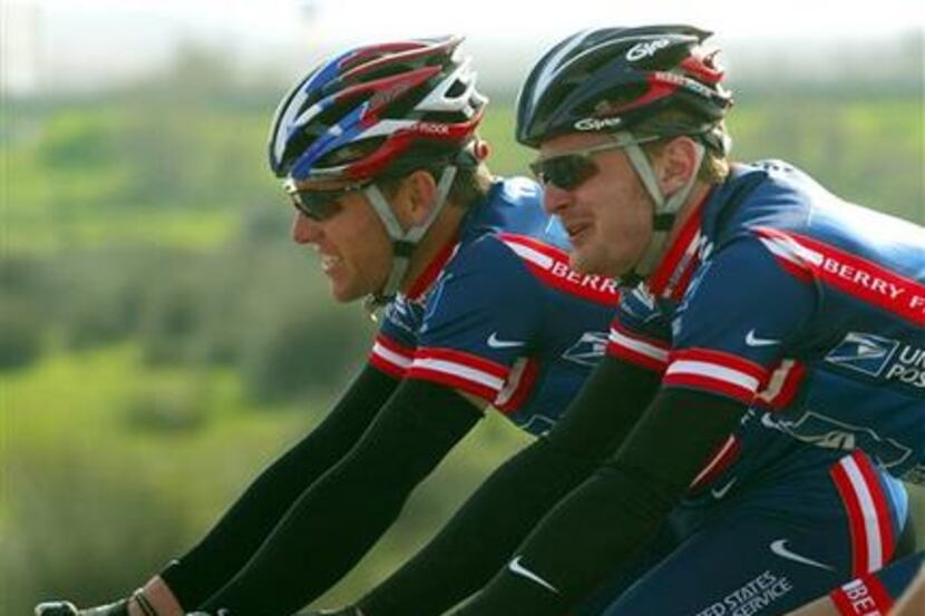 Lance Armstrong (left) and Floyd Landis, both members of the U.S. Postal Service cycling...