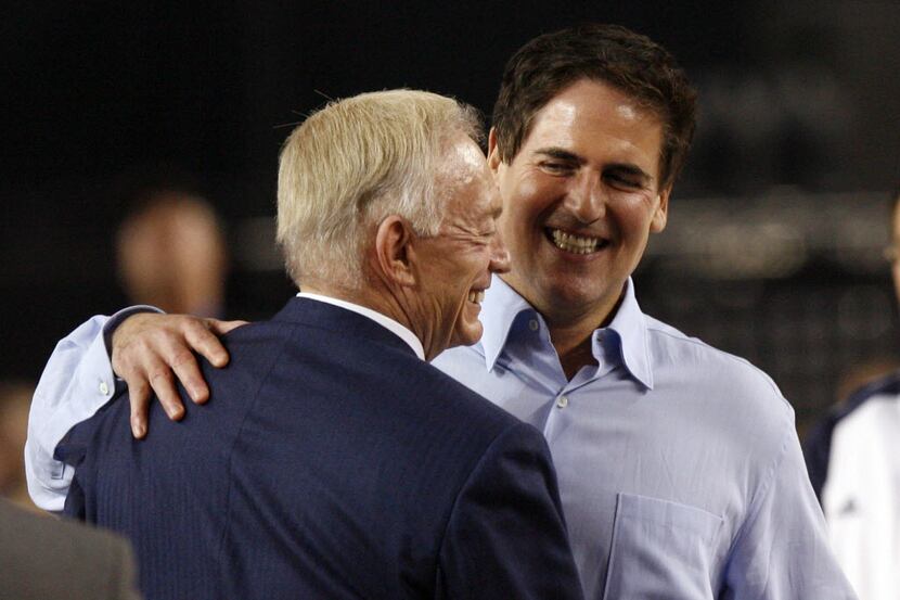 Dallas Cowboys owner Jerry Jones and Dallas Mavericks owner Mark Cuban share a hug after...
