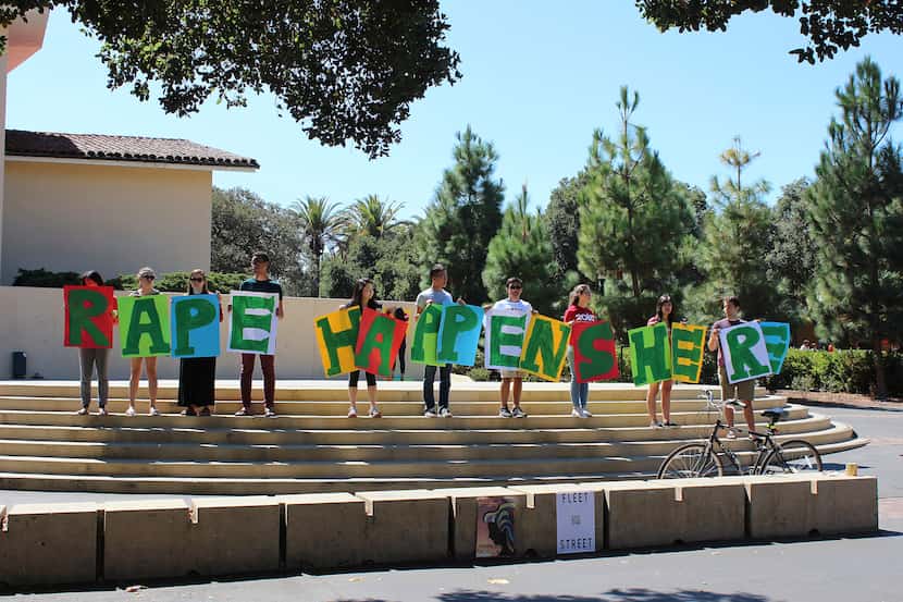 In this Sept. 16, 2015 photo provided by Tessa Ormenyi, students hold up a sign about rape...
