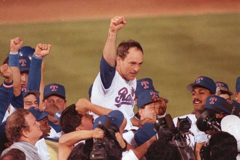 Texas Rangers pitcher Nolan Ryan is carried off the field by his teammates in this May...
