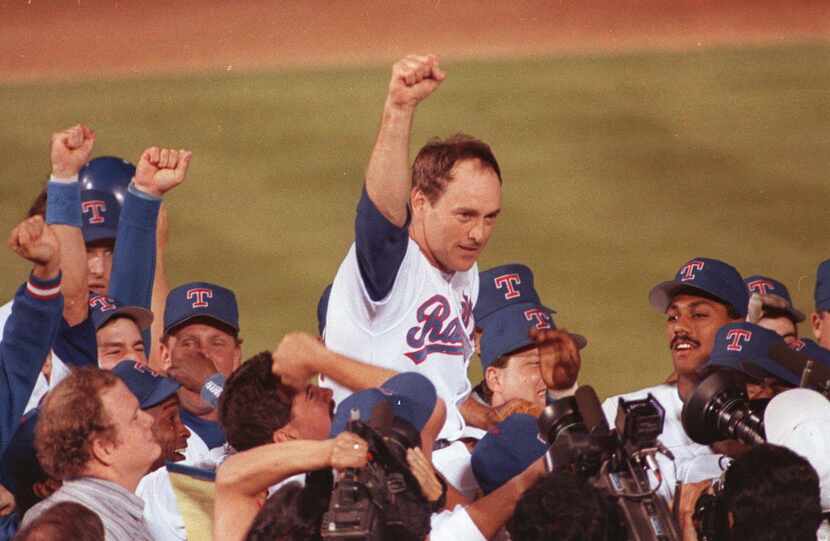 Texas Rangers pitcher Nolan Ryan is carried off the field by his teammates in this May...