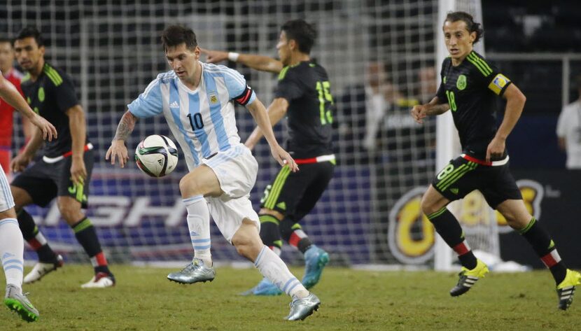 Argentina's Lionel Messi (10) is surrounded by the Mexico defense during the second half...