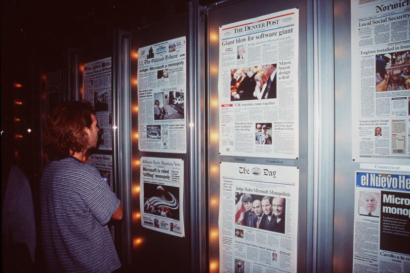 Visitors to the Newseum read front pages of newspapers digitally delivered daily.