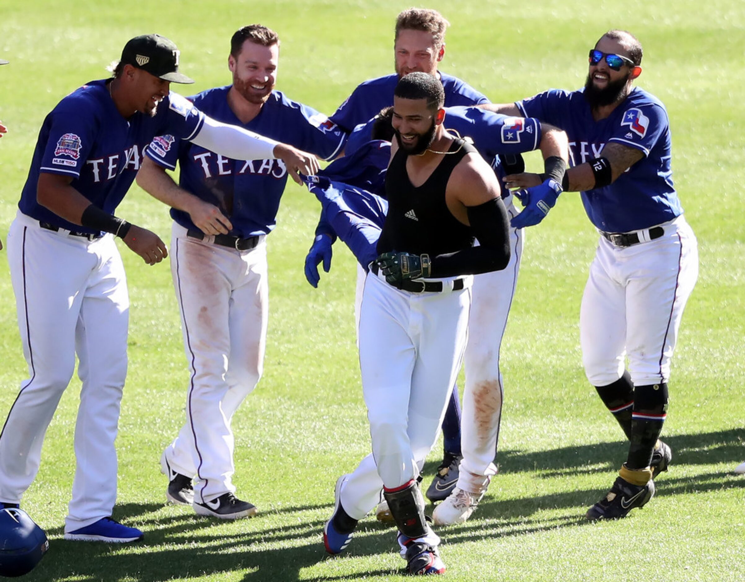 ARLINGTON, TEXAS - MAY 19:  The Texas Rangers celebrate the game winning run scored on a...