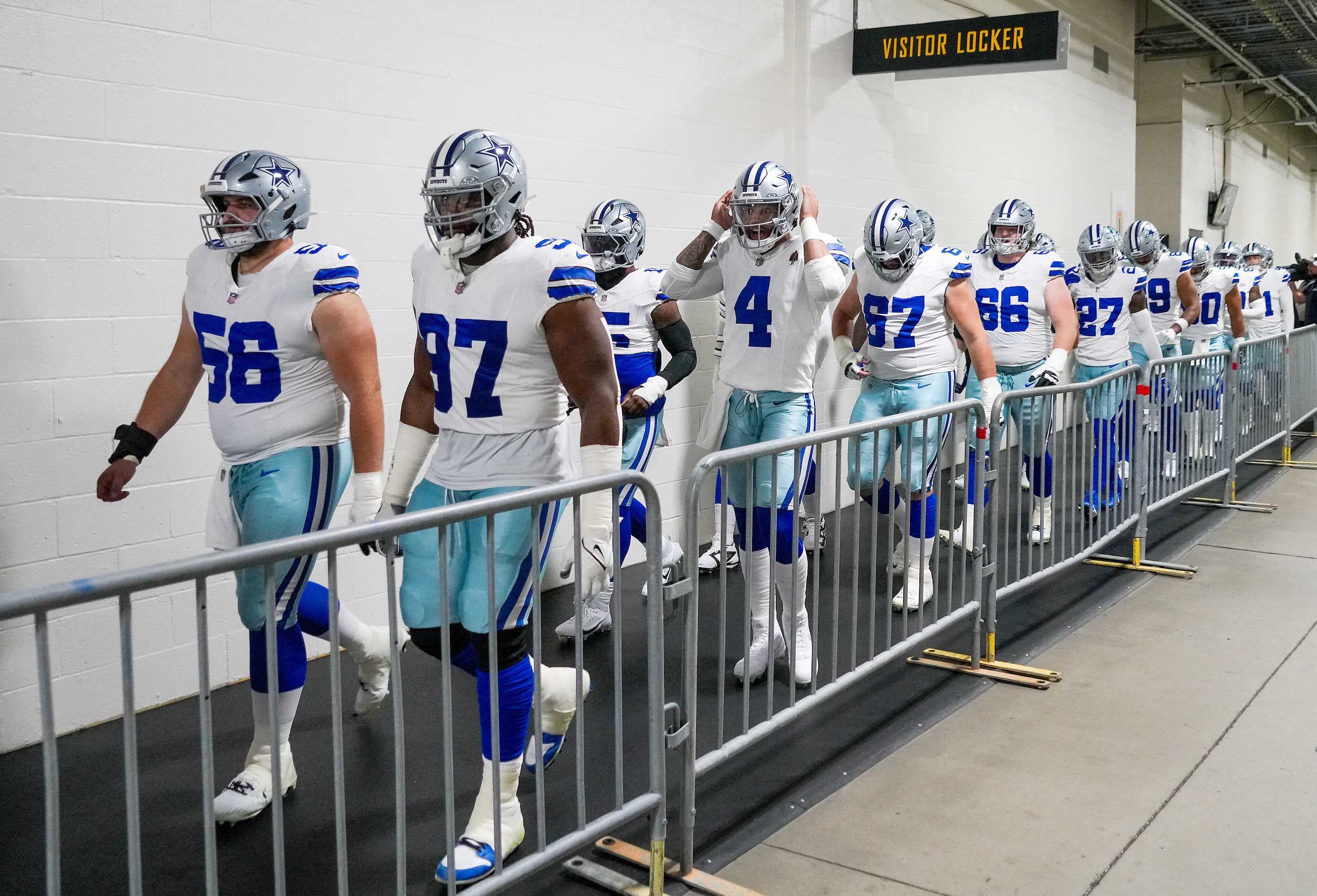 Dallas Cowboys quarterback Dak Prescott (4) follows guard Cooper Beebe (56) and defensive...