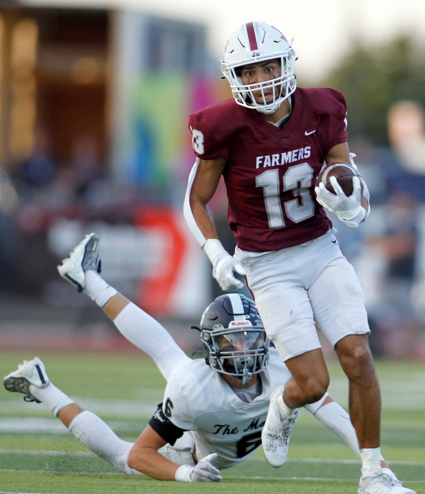 Lewisville receiver JJ Gonzales (13) eludes a diving tackle attempt by Flower Mound safety...