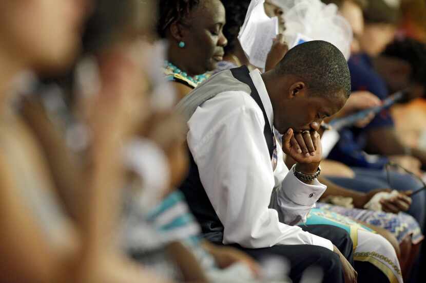 People pray inside Emanuel African Methodist Episcopal Church on Sunday, the first day the...