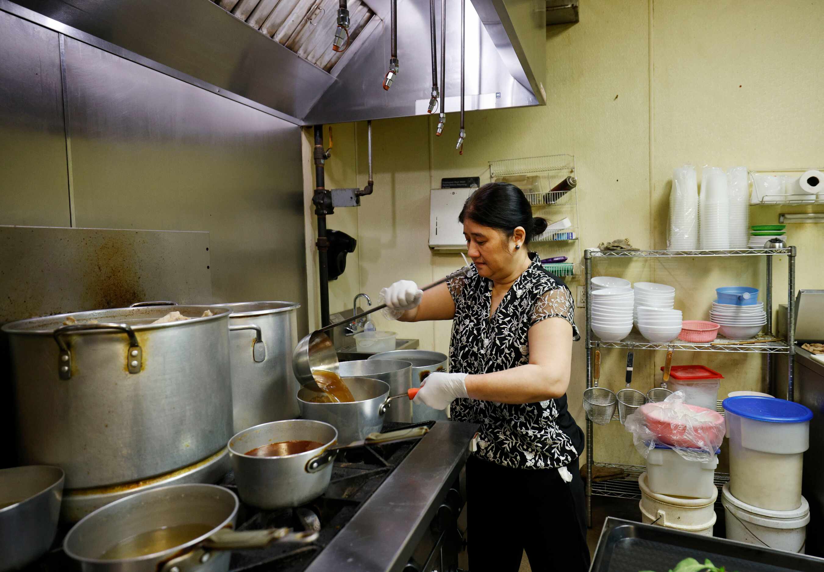 Chef Sa Tran works in the kitchen at her Vietnamese restaurant, Pho Ngon 999 at Asia Times...