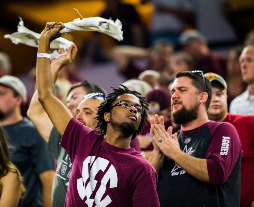 A Texas A&M Aggies fan cheers during the fourth quarter of their game on Saturday, September...