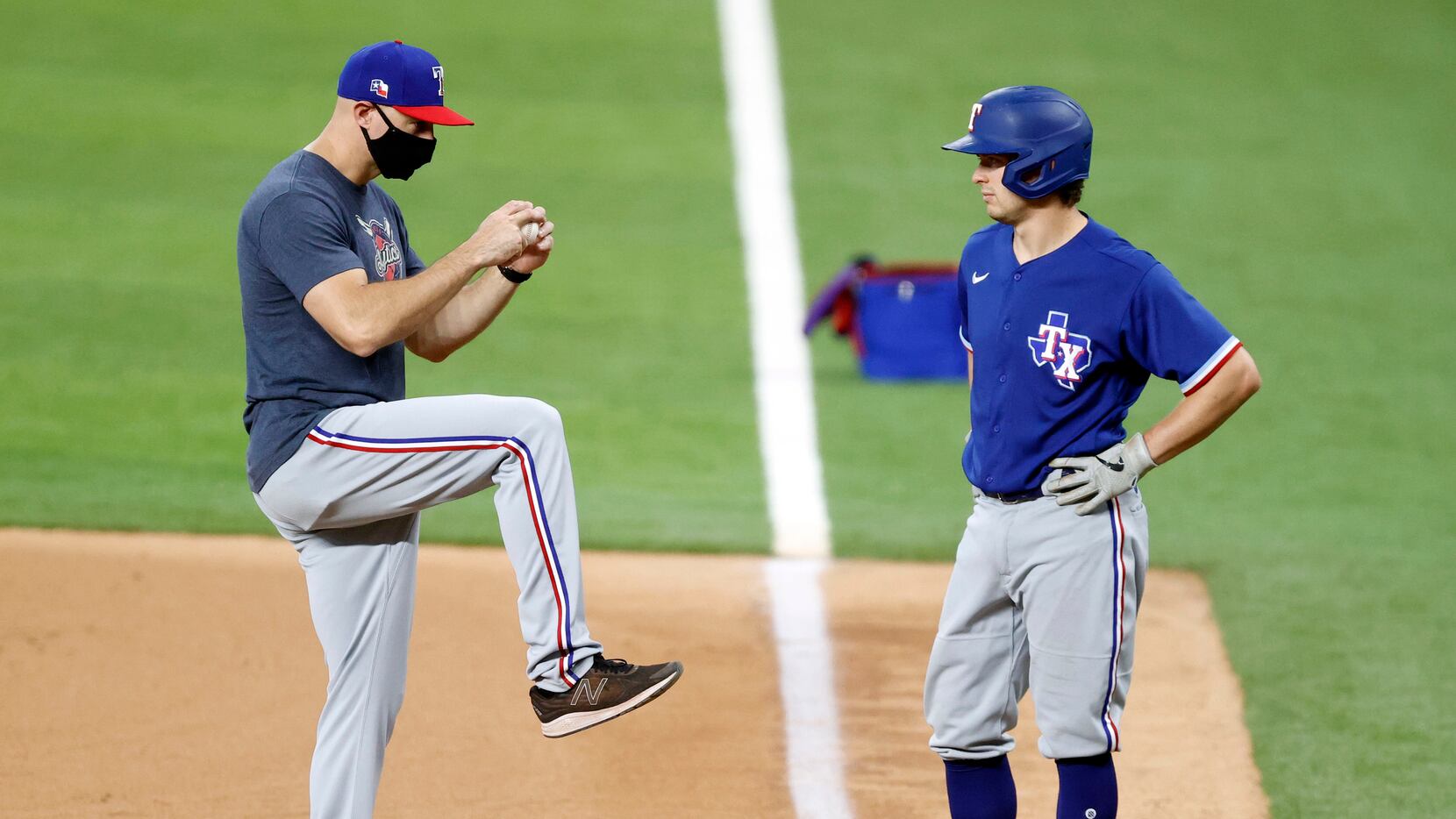 Texas Rangers first base coach Corey Ragsdale (left) delivers some lead off pointers to Nick...