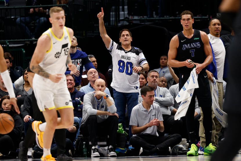 Dallas Mavericks owner Mark Cuban celebrates a three-pointer during the second half of an...