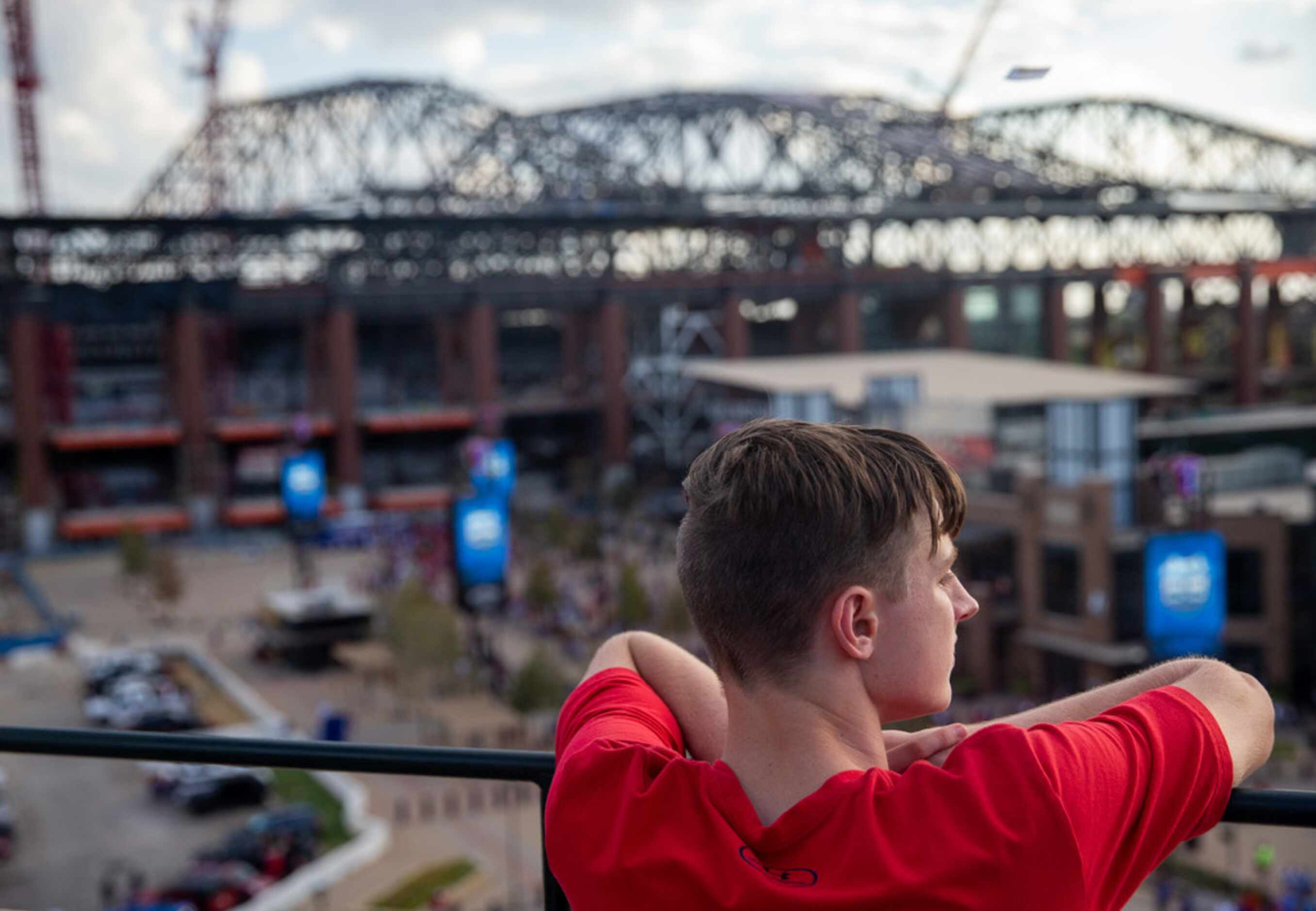 Connor Dill, 16 and from Arlington, looks out at the new Globe Life Field from the top level...