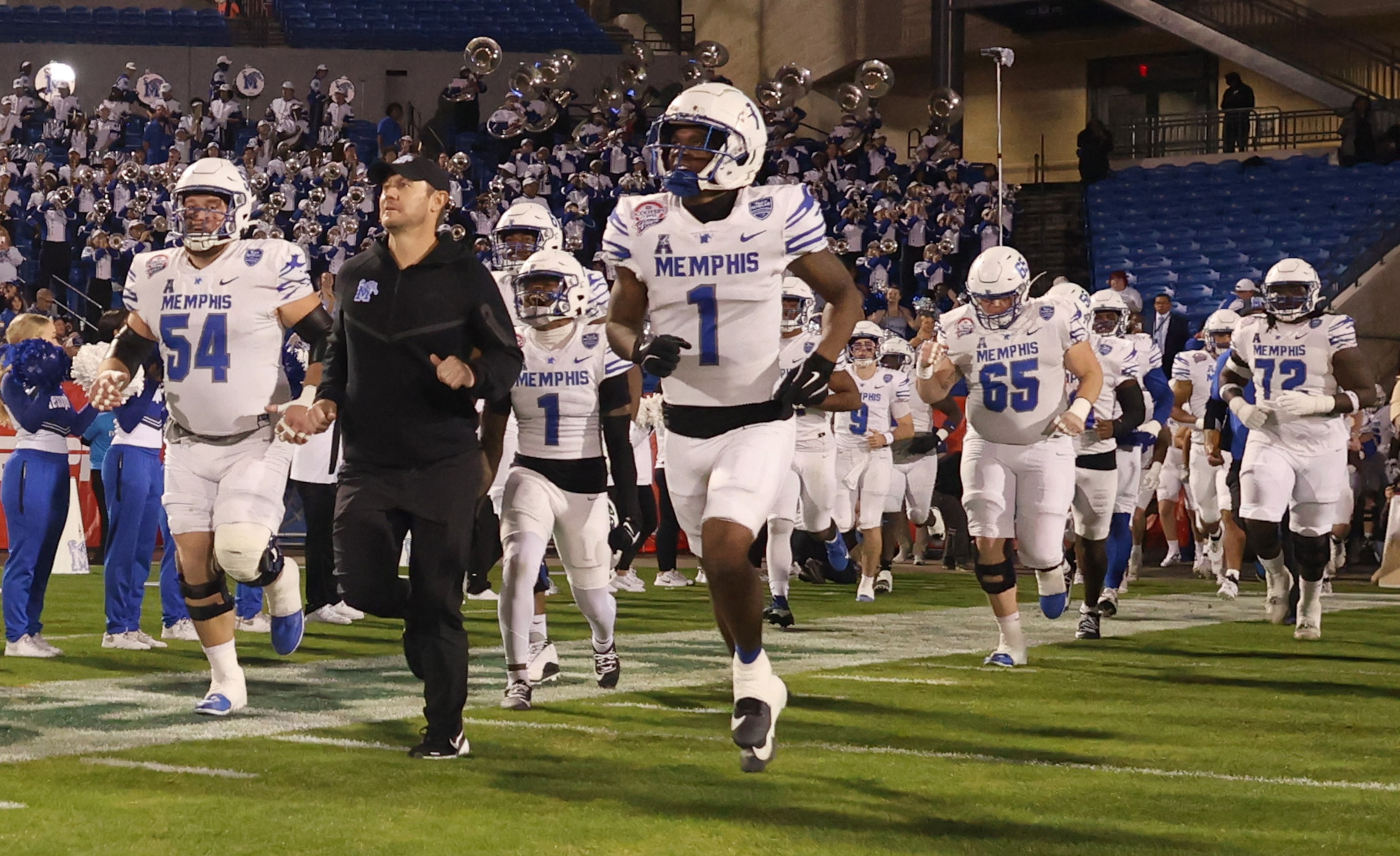 Led by head coach Ryan Silverfield, Memphis players emerge from the tunnel prior to the...