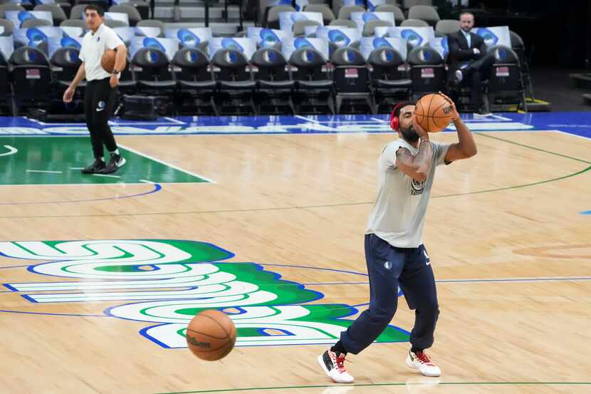 Dallas Mavericks guard Kyrie Irving warms up before the first half of an NBA basketball game...