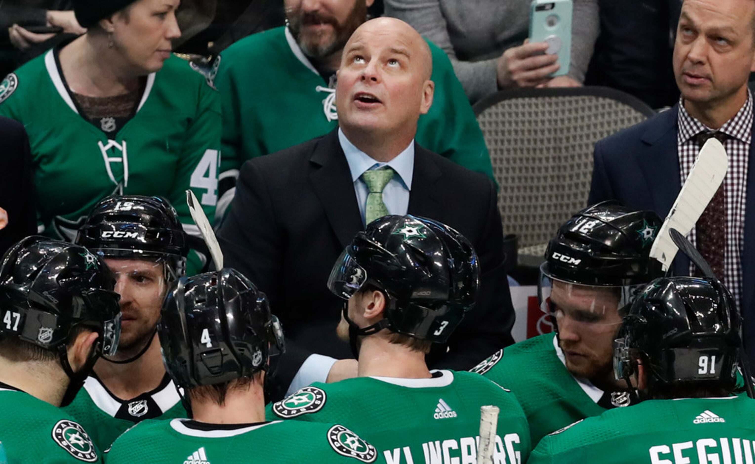 Dallas Stars head coach Jim Montgomery looks up from the time out during the third period of...