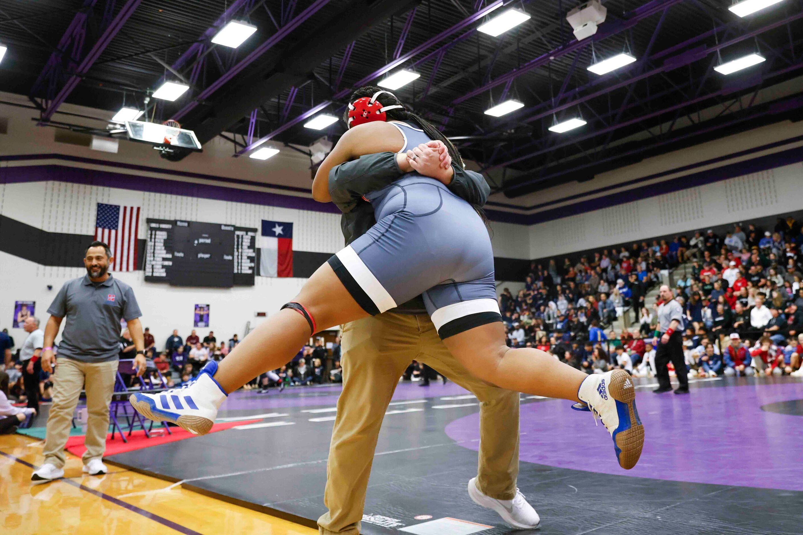 Colling Stroner head coach of Midlothian Heritage cheer with Kendall Jones over her victory...