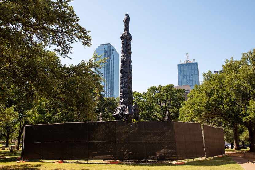 The statues and monument of the Confederate War Memorial are fenced in and wrapped with...