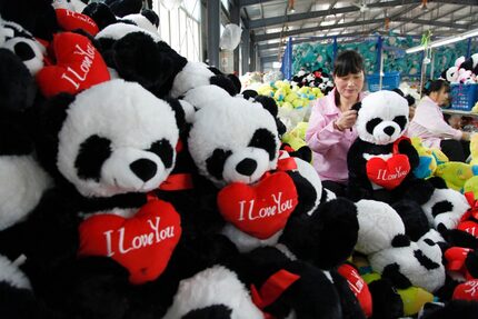 This picture taken on October 12, 2016 shows a Chinese worker making soft toys at a toy...