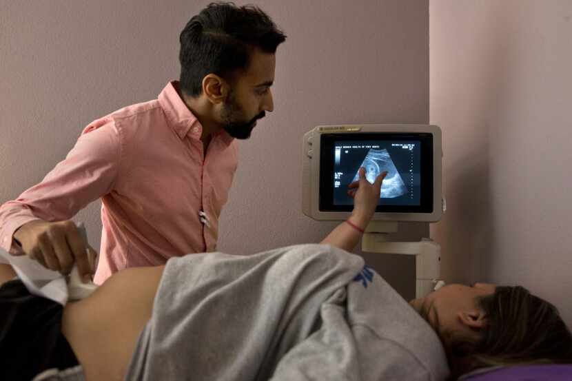 Dr. Bhavik Kumar, 31, listens to a question from a patient considering abortion during her...