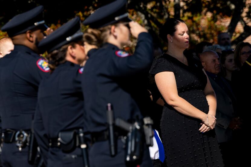 Cristl Nothem closes her eyes during a funeral service for her husband Carrollton police...
