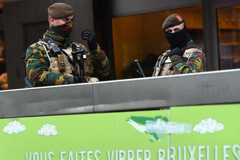 Soldiers patrol in the streets Tuesday in Brussels as the Belgian capital began a fourth...