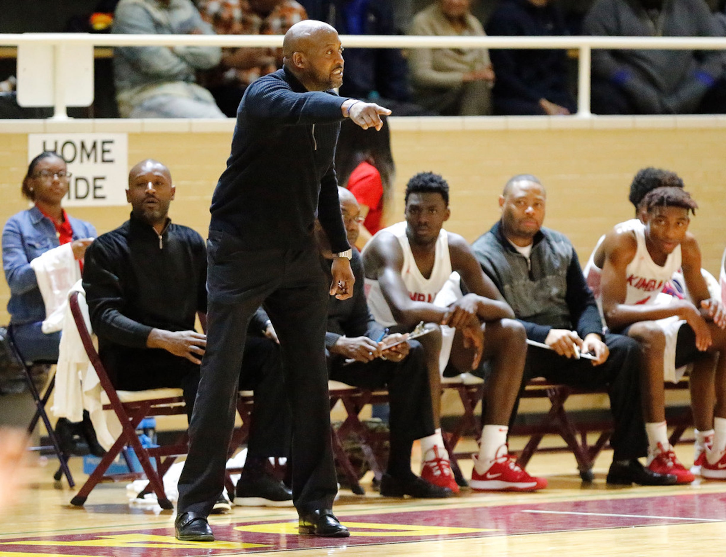 Kimball High School head coach Nicholas Smith gives direction during the first half as...