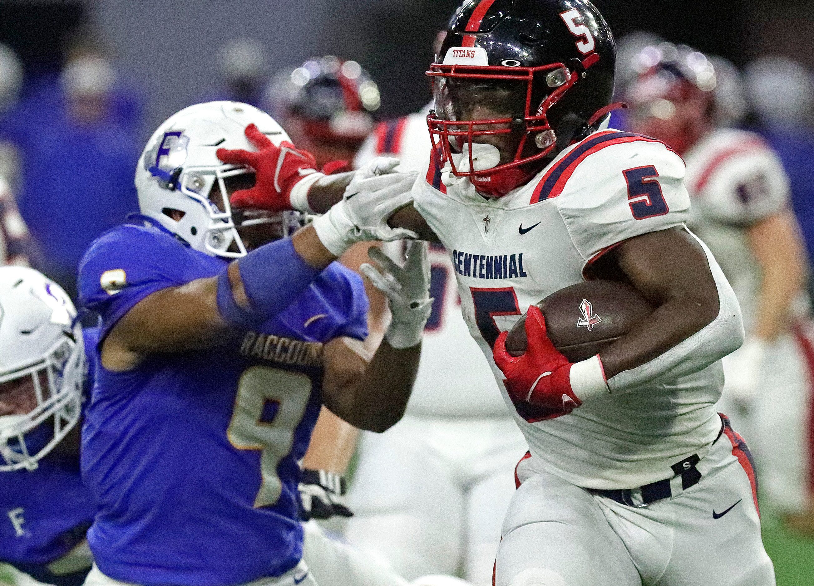 Centennial High School Harry Stewart (5) puts a stiff arm on Frisco High School linebacker...