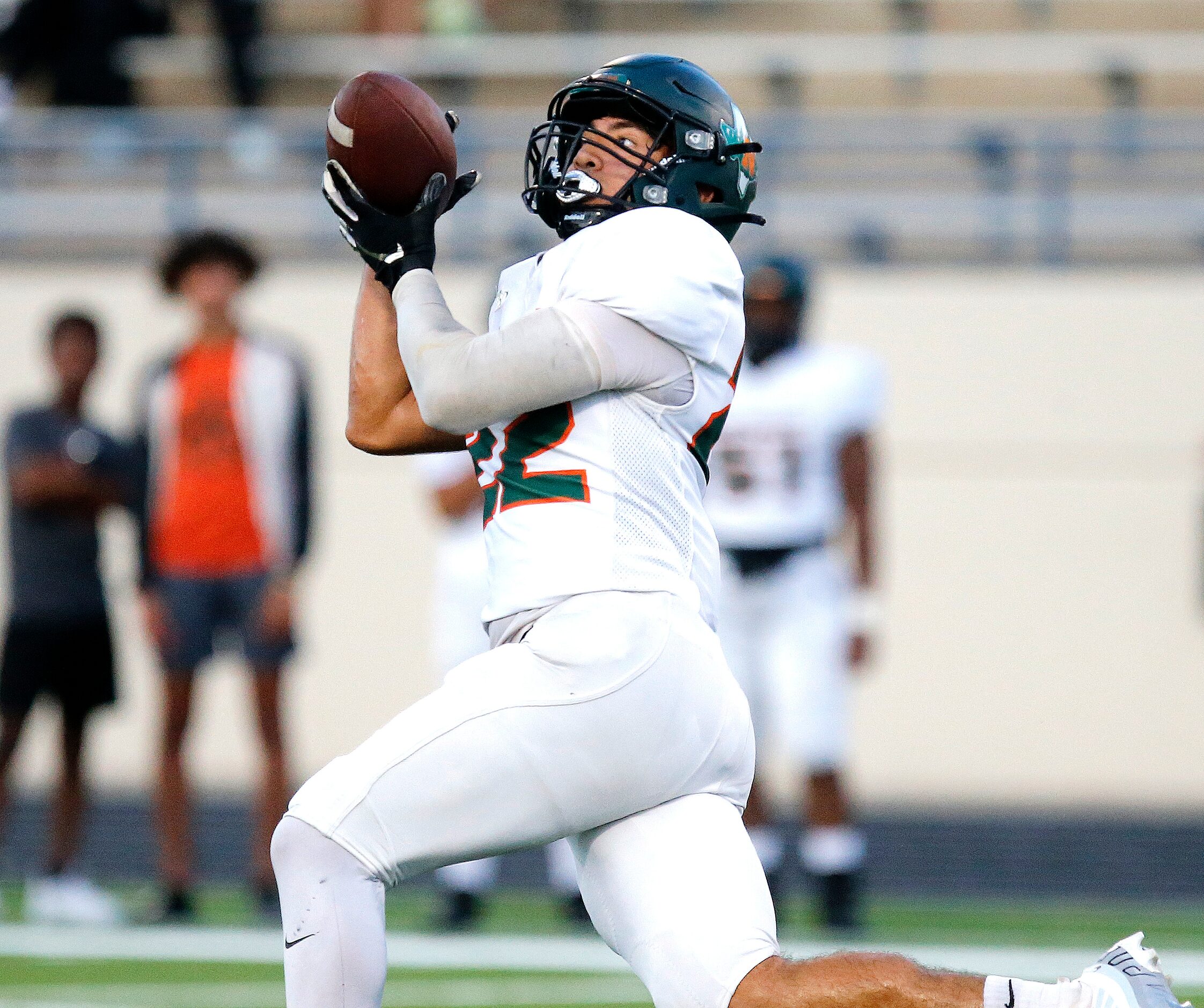 Naaman Forrest High School wide receiver Jason Flores (22) catches a 90 yard touchdown pass...