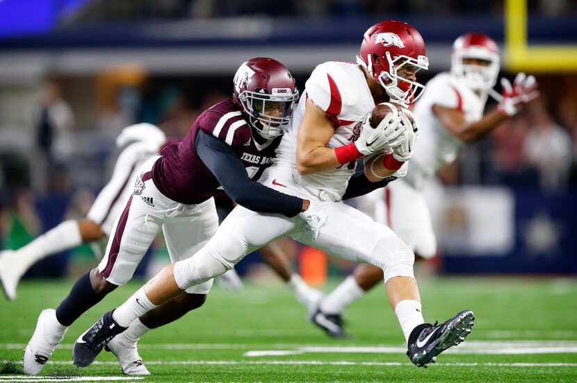FILE - Arkansas Razorbacks wide receiver Drew Morgan (80) is tackled by Texas A&M Aggies...