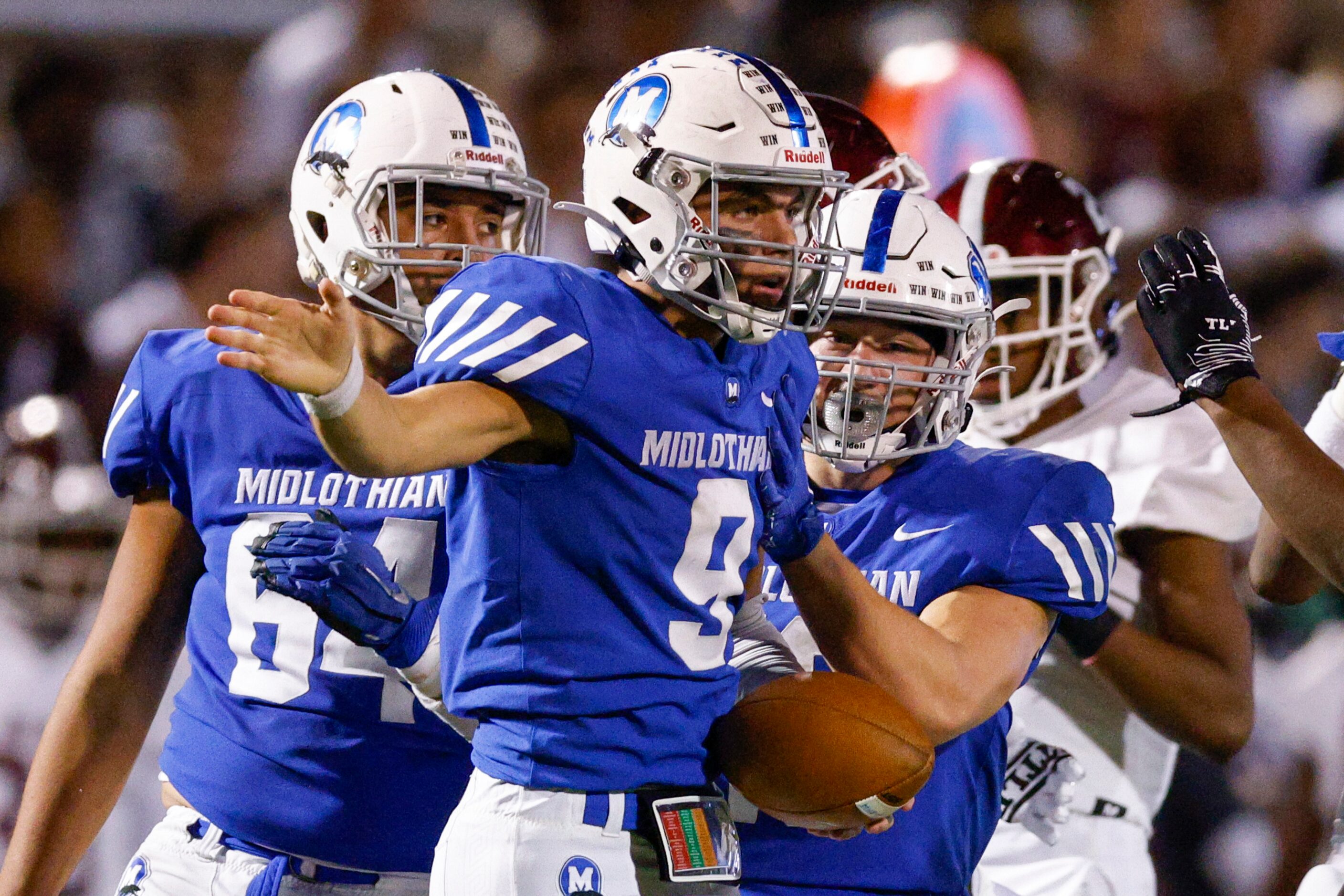 Midlothian quarterback Chad Ragle (9) signals a first down after a run during the second...