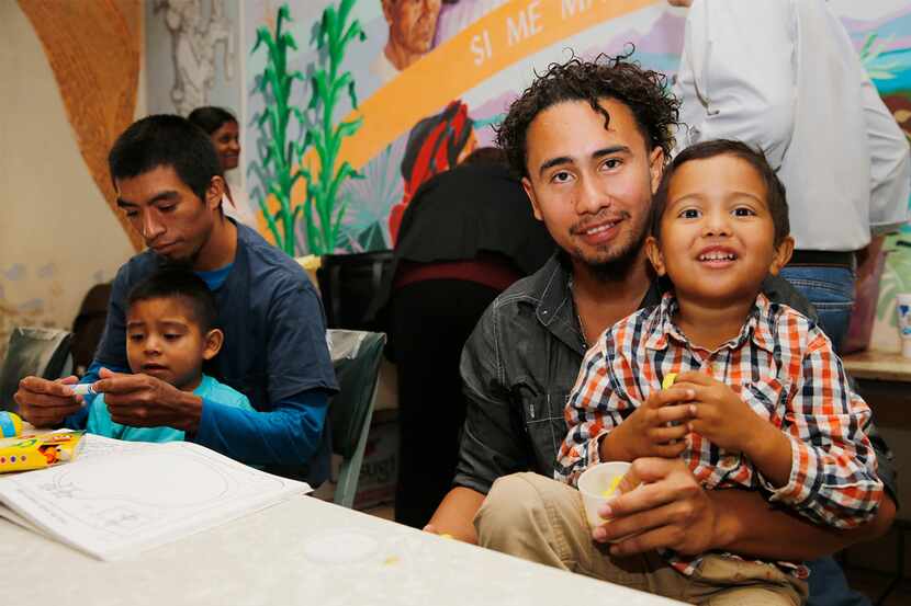 Roger Ardino, 24, and his son Roger Ardino Jr., 4, pose for a photo as they and Pablo Ortiz,...