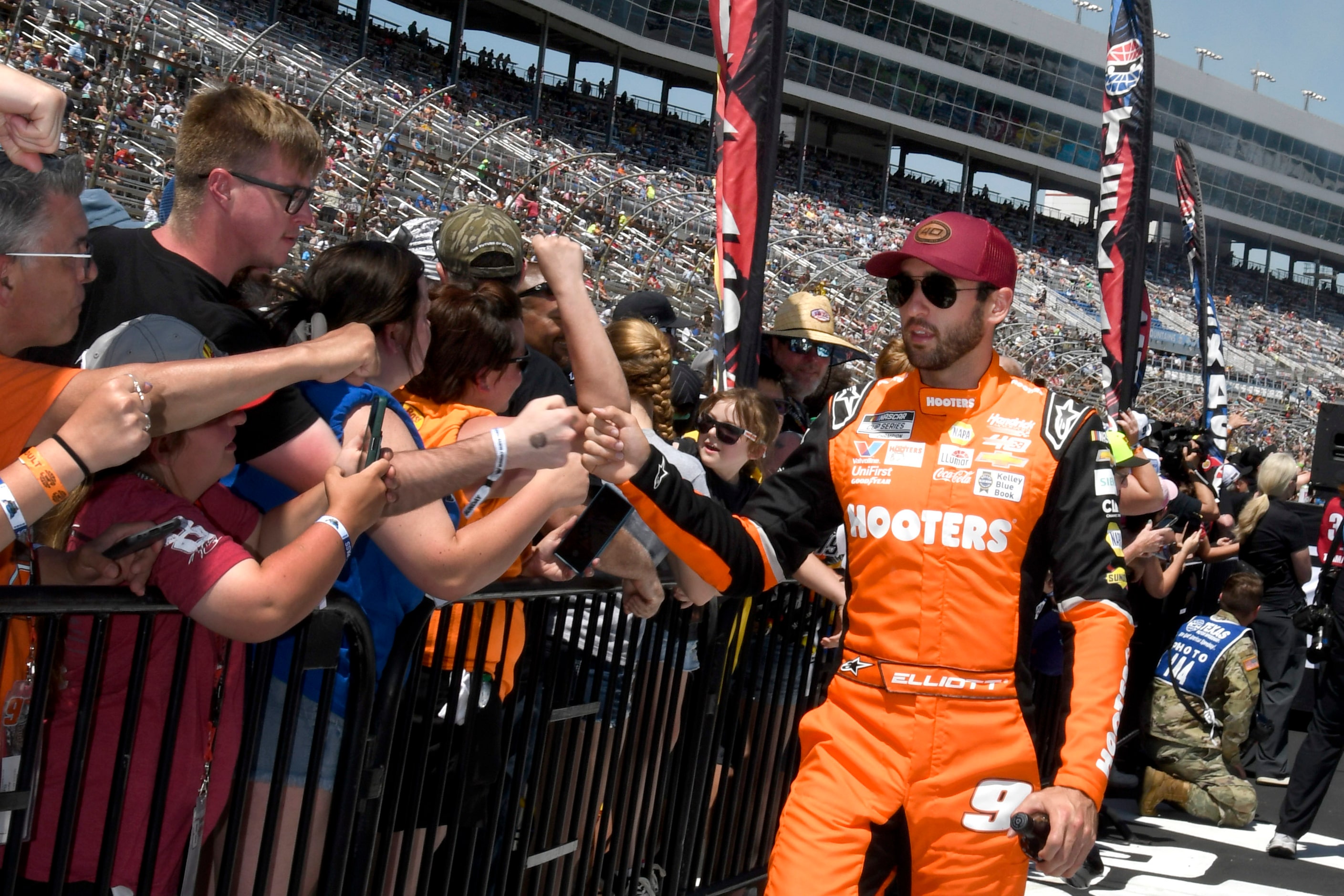 Chase Elliott, right, greets fans during driver introductions before a NASCAR Cup Series...